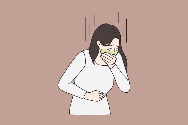 Woman experiencing nausea after embryo transfer, related to IVF process.